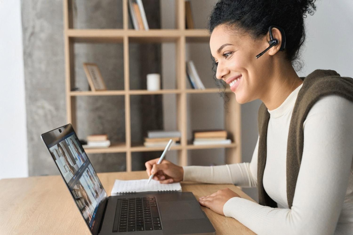 Candidate wearing a headset revising MCQs on a laptop for a postgraduate medical exam